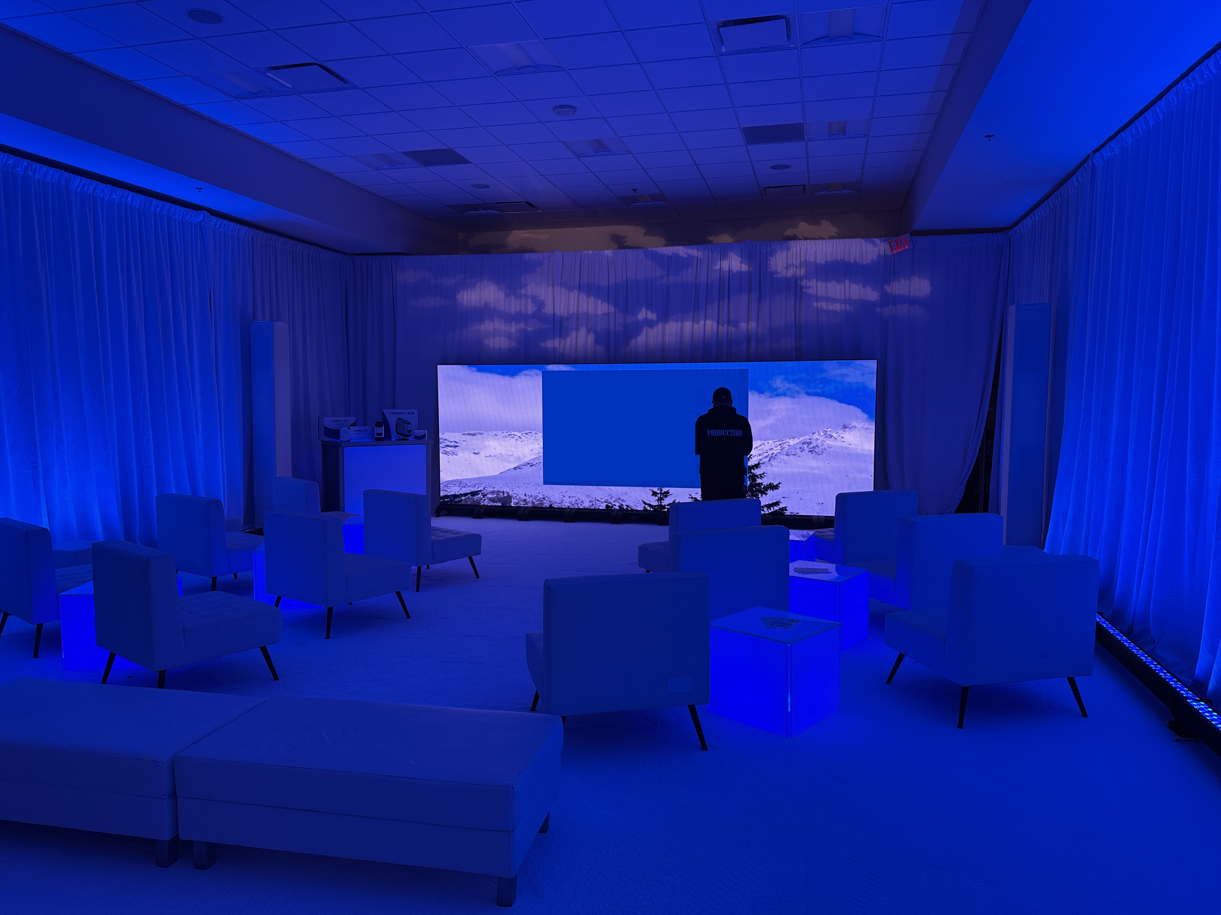 Ballroom set with projection screens, stage and front-of-house audio and lighting desk